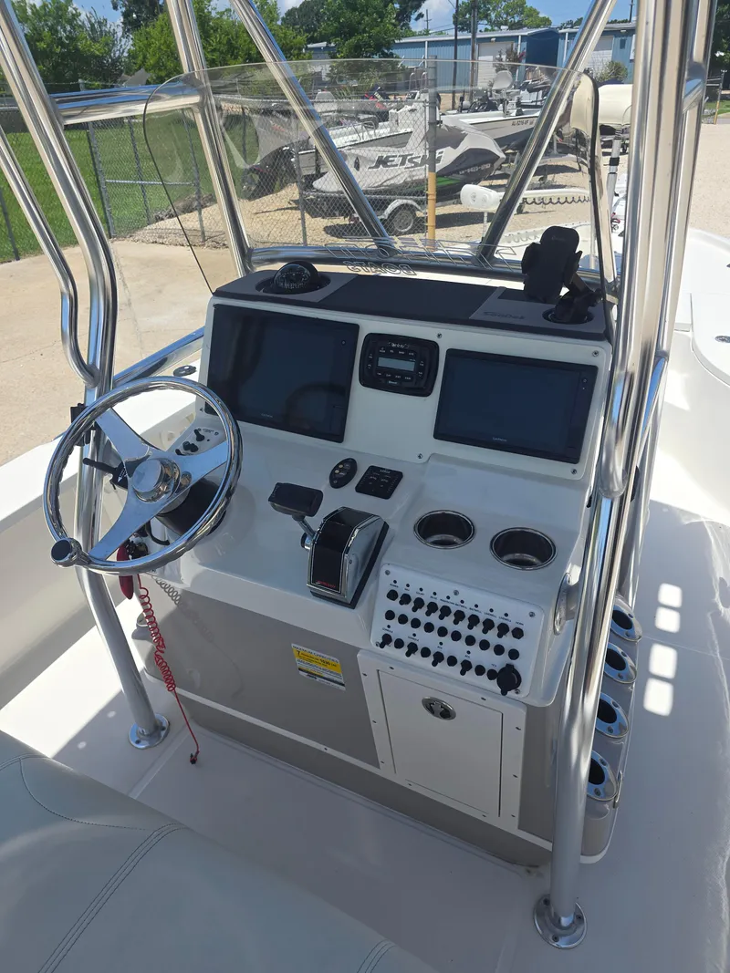 Slide: The Image of 2014 Triton 240 LTS Pro boat console with steering wheel and navigation controls. - 11