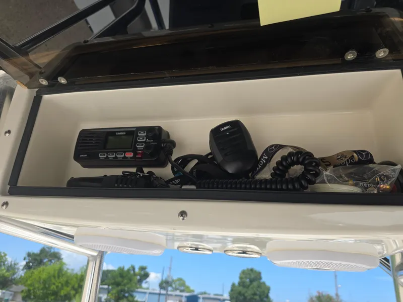 Slide: The Image of Storage compartment in a 2014 Triton 240 LTS Pro boat with communication equipment. - 12