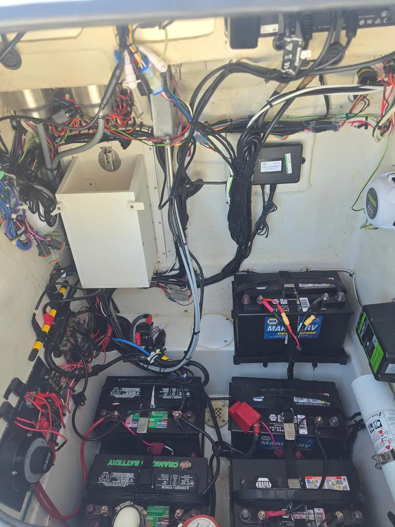 Slide: The Image of Electrical wiring and batteries inside a 2014 Triton 240 LTS Pro boat. - 15