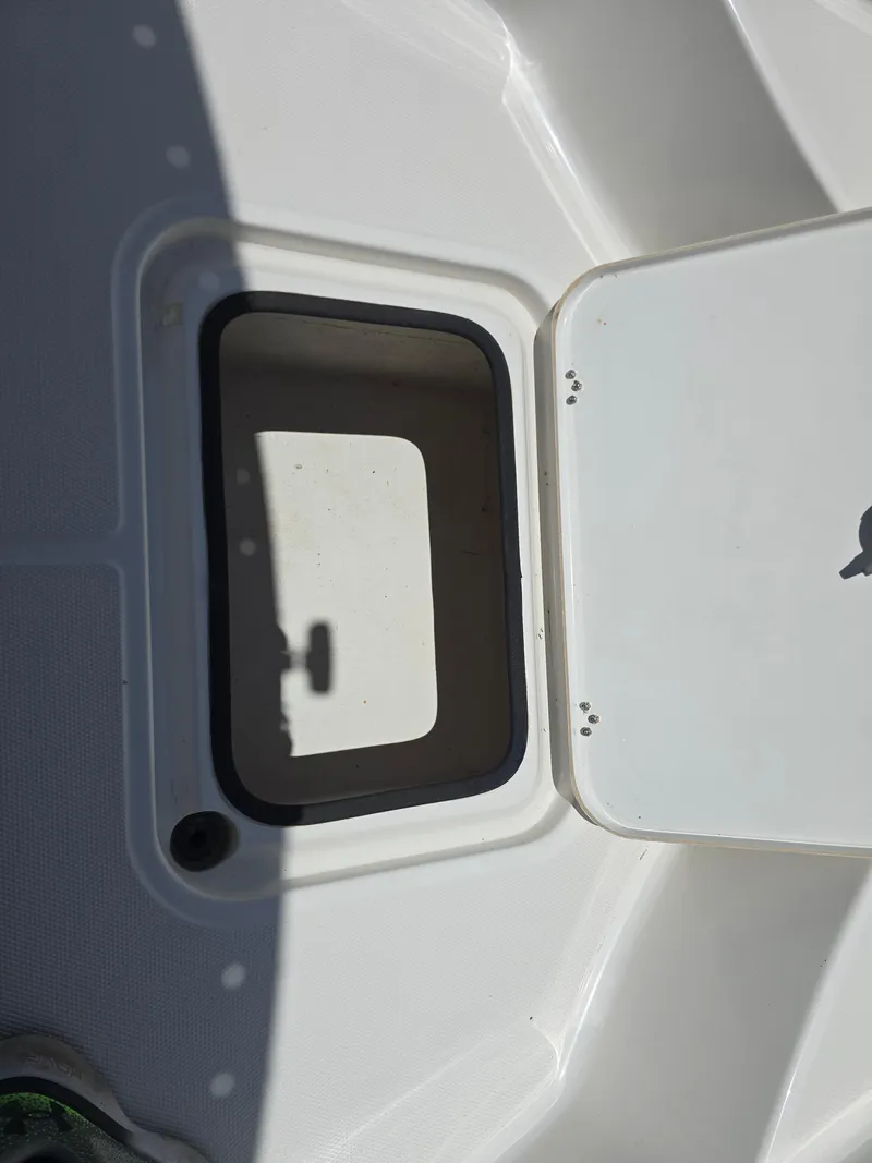 Slide: The Image of Open storage compartment on 2014 Triton 240 LTS Pro boat deck. - 16