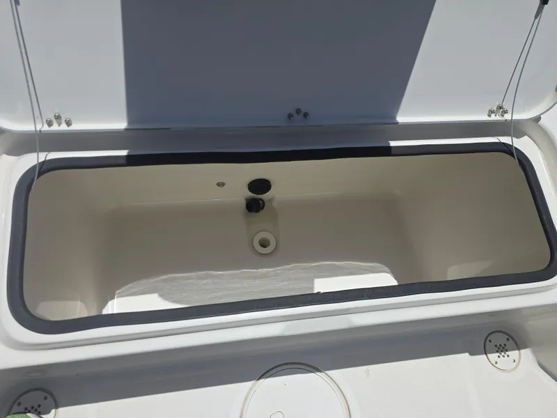 Slide: The Image of Open storage compartment on a 2014 Triton 240 LTS Pro boat. - 18