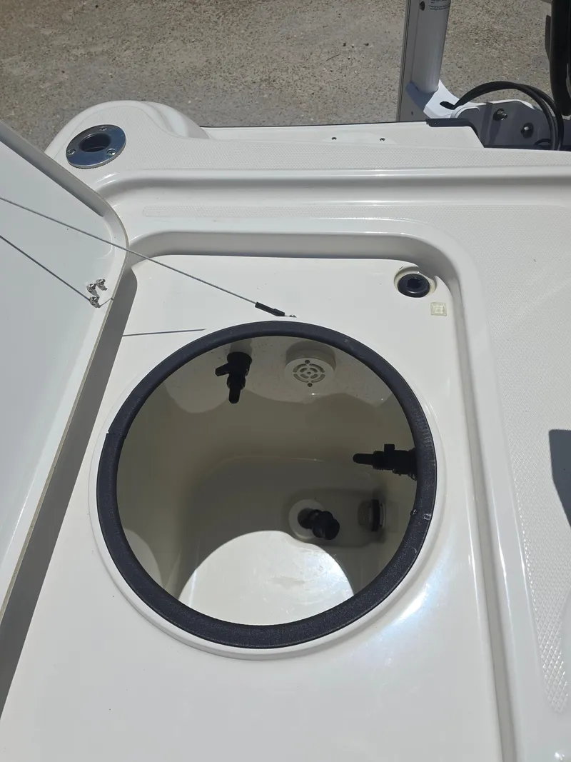 Slide: The Image of Open storage compartment on 2014 Triton 240 LTS Pro boat deck. - 19