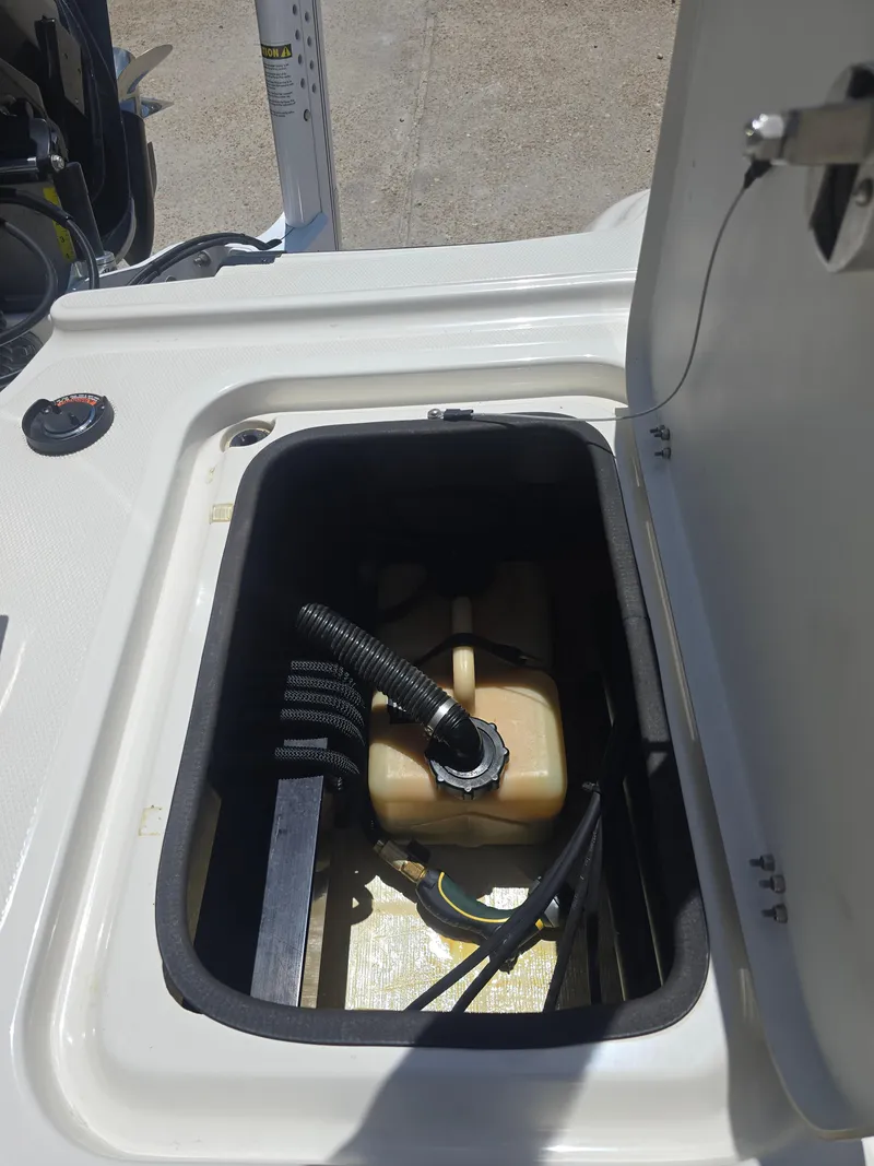Slide: The Image of Open storage compartment in a 2014 Triton 240 LTS Pro boat. - 20
