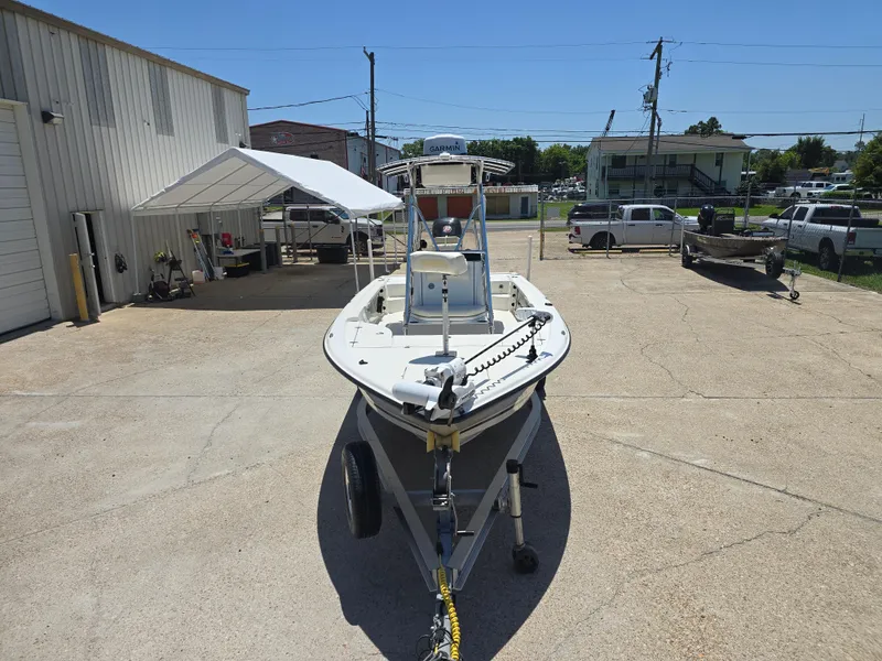 Slide: The Image of 2014 Triton 240 LTS Pro boat on trailer in outdoor setting. - 4