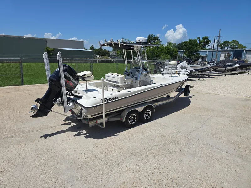 Slide: The Image of 2014 Triton 240 LTS Pro boat on trailer in outdoor setting. - 6