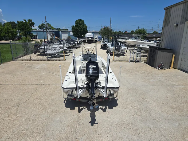 Slide: The Image of 2014 Triton 240 LTS Pro boat with powerful engine in a boatyard setting. - 7