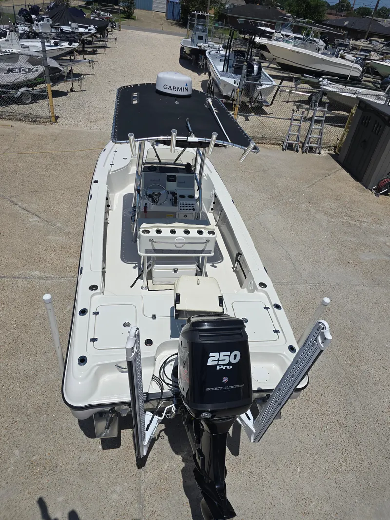 Slide: The Image of 2014 Triton 240 LTS Pro boat with Garmin equipment and 250 Pro engine in a marina. - 8