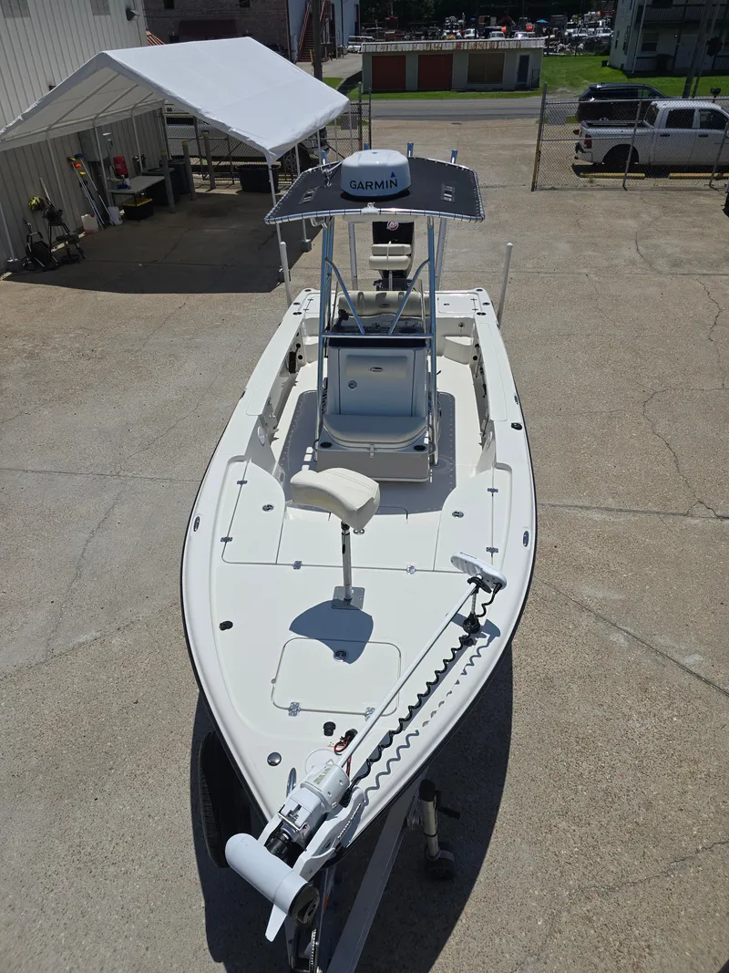 Slide: The Image of 2014 Triton 240 LTS Pro boat with Garmin equipment, parked on concrete. - 9