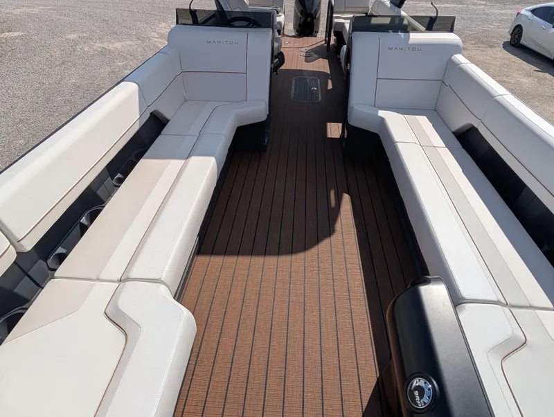 Slide: The Image of 2025 Manitou Explore boat interior with spacious seating and sleek design. - 11