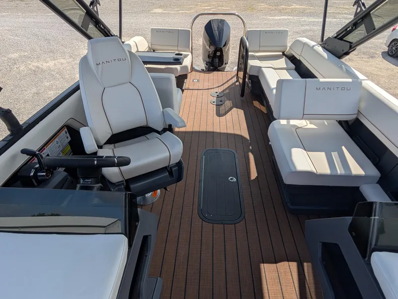 Slide: The Image of 2025 Manitou Explore boat interior with luxurious seating and modern design. - 12