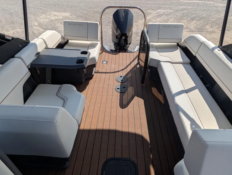 Slide: The Image of 2025 Manitou Explore boat interior with spacious seating and modern design. - 13