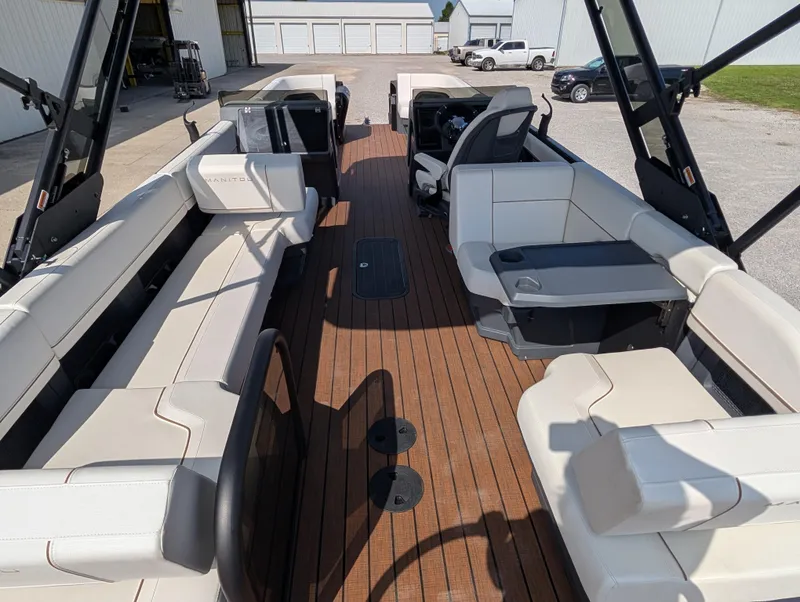 Slide: The Image of 2025 Manitou Explore boat interior with spacious seating and modern design. - 16