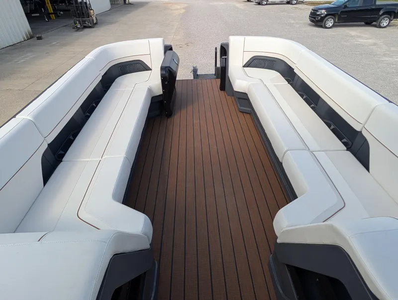 Slide: The Image of 2025 Manitou Explore boat interior with spacious seating and sleek design. - 27