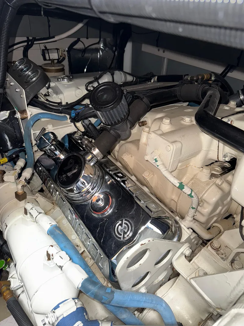 Slide: The Image of Engine compartment of a 1998 Sea Ray 540 Sundancer boat, showcasing mechanical components. - 12