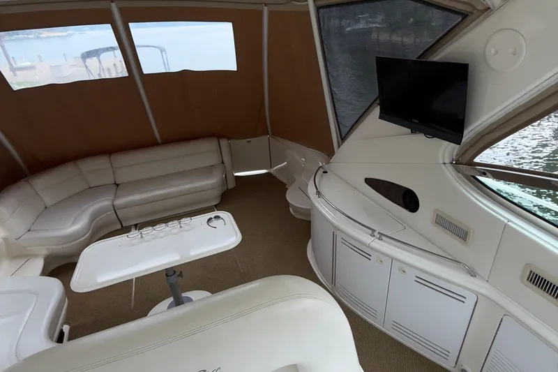 Slide: The Image of Luxurious interior of 1998 Sea Ray 540 Sundancer yacht with seating and TV. - 14