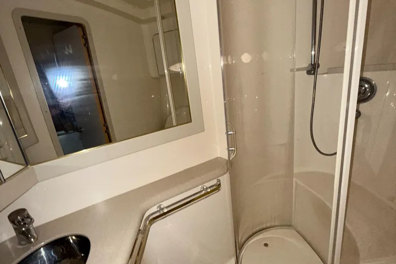 Slide: The Image of Bathroom interior of 1998 Sea Ray 540 Sundancer yacht, featuring shower and sink. - 17