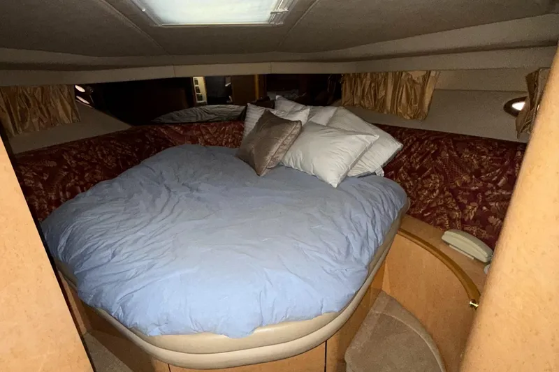 Slide: The Image of Luxurious bedroom interior of 1998 Sea Ray 540 Sundancer yacht with cozy bedding. - 23