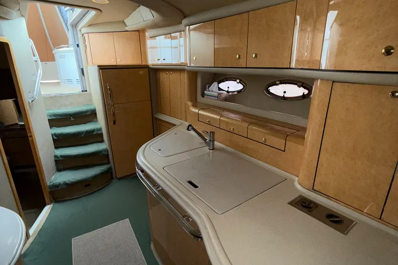 Slide: The Image of Interior of 1998 Sea Ray 540 Sundancer yacht with kitchen and stairs. - 24