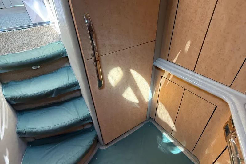 Slide: The Image of Interior stairs of 1998 Sea Ray 540 Sundancer yacht with teal carpet. - 6