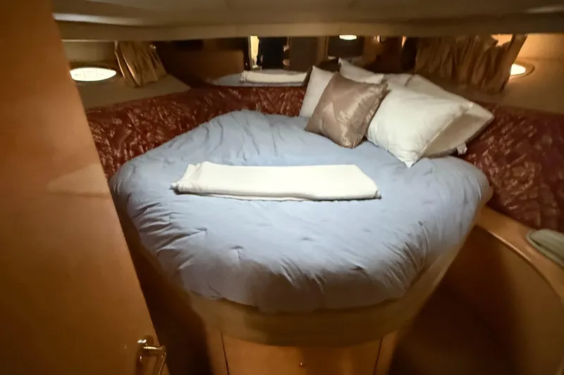 Slide: The Image of Cozy bedroom interior of 1998 Sea Ray 540 Sundancer yacht with plush bedding. - 7