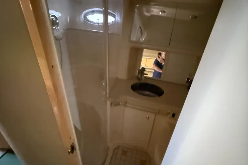 Slide: The Image of Bathroom interior of 1998 Sea Ray 540 Sundancer yacht, featuring sink and shower. - 8
