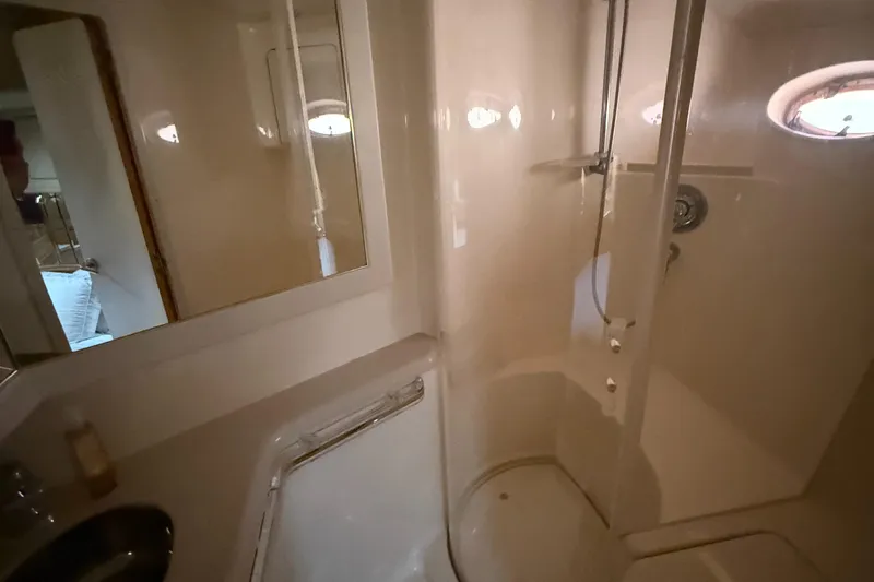 Slide: The Image of Bathroom interior of 1998 Sea Ray 540 Sundancer yacht, featuring shower and mirror. - 9