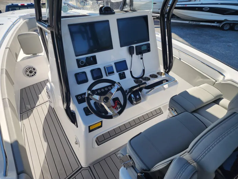Slide: The Image of 2025 Cape Horn 32 XS boat cockpit with dual screens and modern controls. - 13