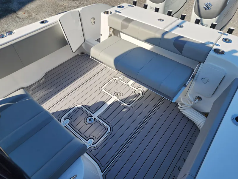 Slide: The Image of 2025 Cape Horn 32 XS boat interior with gray seating and deck, featuring Suzuki engines. - 18