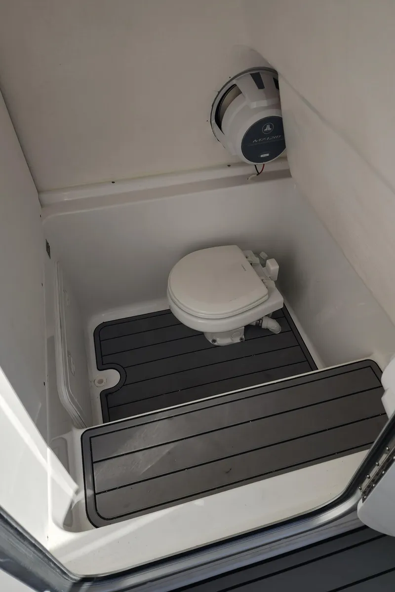 Slide: The Image of 2025 Cape Horn 32 XS boat bathroom with toilet and marine speaker. - 22