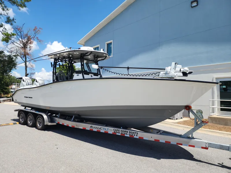 Slide: The Image of 2025 Cape Horn 32 XS boat on trailer, parked outdoors near a building. - 3