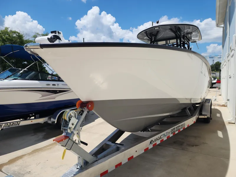 Slide: The Image of 2025 Cape Horn 32 XS boat on trailer under clear blue sky. - 5
