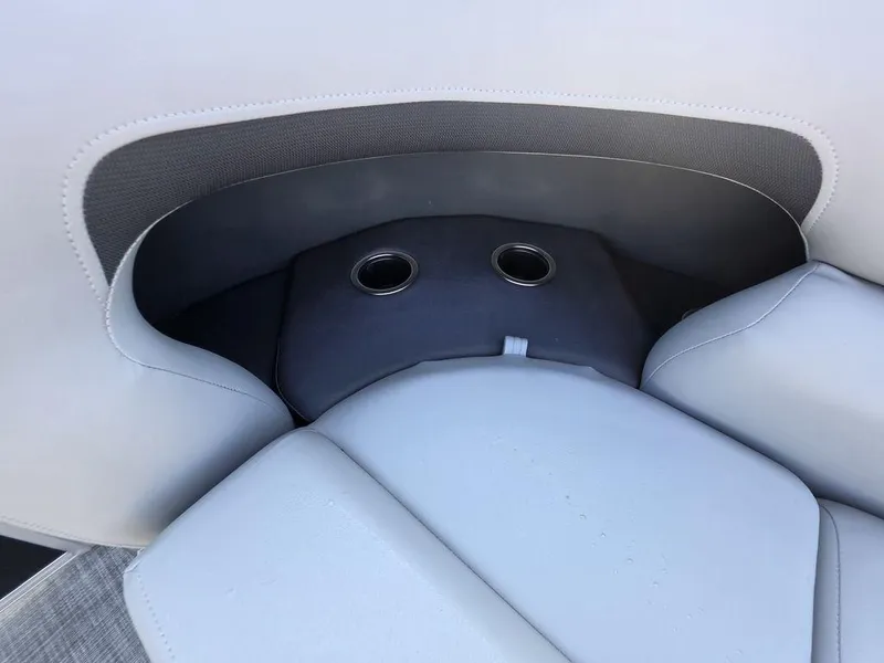 Slide: The Image of 2026 Sun Tracker Party Barge 20 DLX with open storage compartment and cushioned seating. - 12