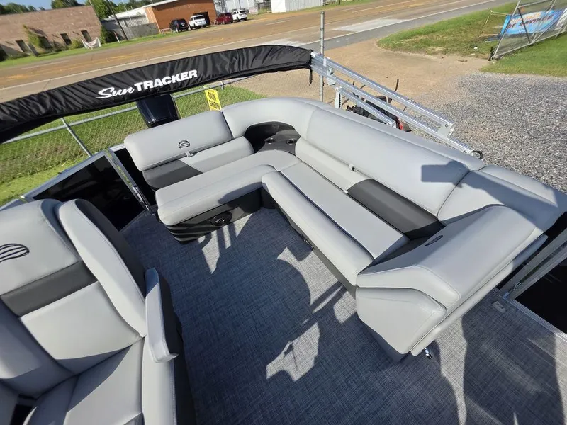 Slide: The Image of 2026 Sun Tracker Party Barge 20 DLX interior with open storage compartment and seating. - 13