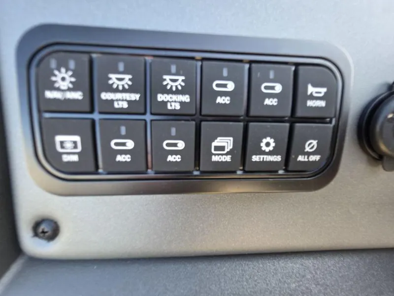 Slide: The Image of 2026 Sun Tracker Party Barge 20 DLX interior with steering console and seating. - 14