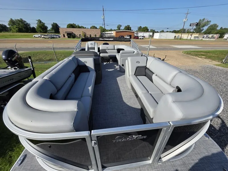 Slide: The Image of 2026 Sun Tracker Party Barge 20 DLX pontoon boat on trailer, parked outdoors. - 5