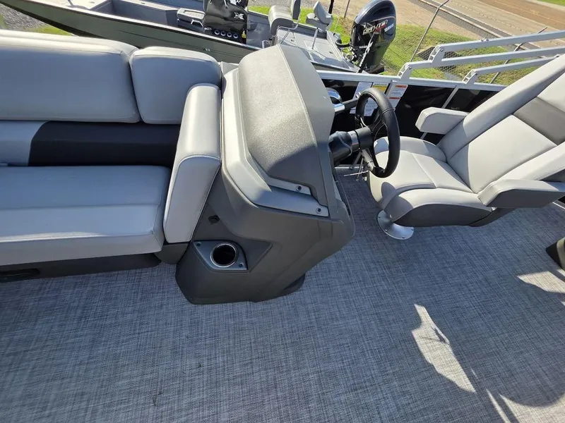 Slide: The Image of 2026 Sun Tracker Party Barge 20 DLX with comfortable gray seating and cup holders. - 6