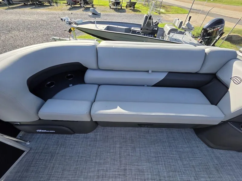 Slide: The Image of 2026 Sun Tracker Party Barge 20 DLX pontoon boat with Mercury engine, docked outdoors. - 8