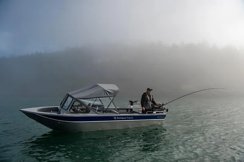 Slide: The Image of 2025 Spartan 20 Areus boat with fisherman on misty lake. - 13