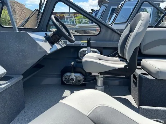 Slide: The Image of Interior of 2025 Spartan 20 Areus boat with steering wheel and seating. - 8