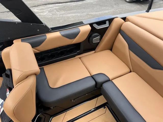 Slide: The Image of 2024 Axis Wake Research A20 boat interior with tan and black seating. - 11