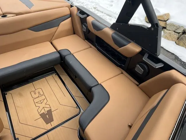 Slide: The Image of 2024 Axis Wake Research A20 boat interior with tan and black seating, showcasing modern design. - 12
