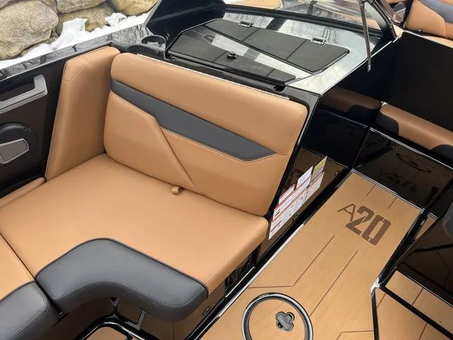 Slide: The Image of 2024 Axis Wake Research A20 boat interior with tan and black seating. - 13