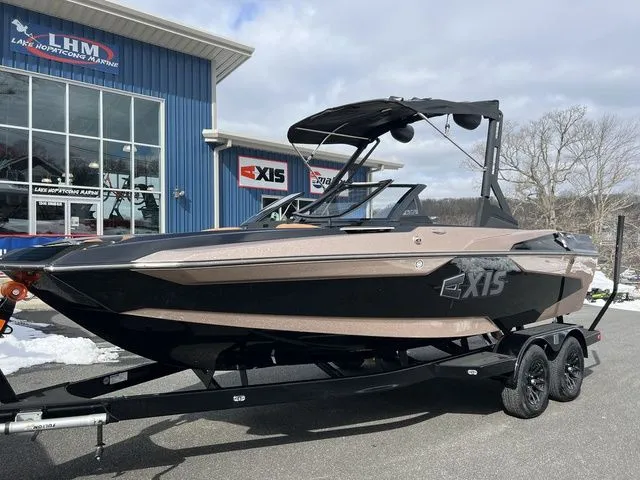 Slide: The Image of 2024 Axis Wake Research A20 boat on trailer outside dealership. - 5