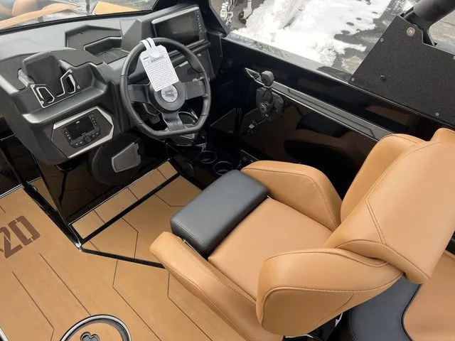 Slide: The Image of 2024 Axis Wake Research A20 boat interior with tan seats and modern dashboard. - 7