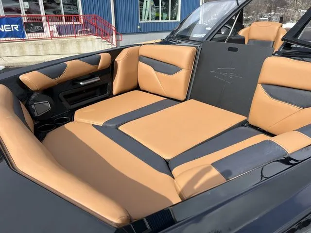 Slide: The Image of 2024 Axis Wake Research A20 boat interior with tan and black seating. - 9