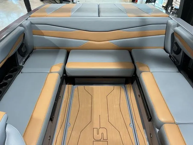 Slide: The Image of 2024 Axis Wake Research A225 boat interior with gray and tan seating, stylish design. - 5