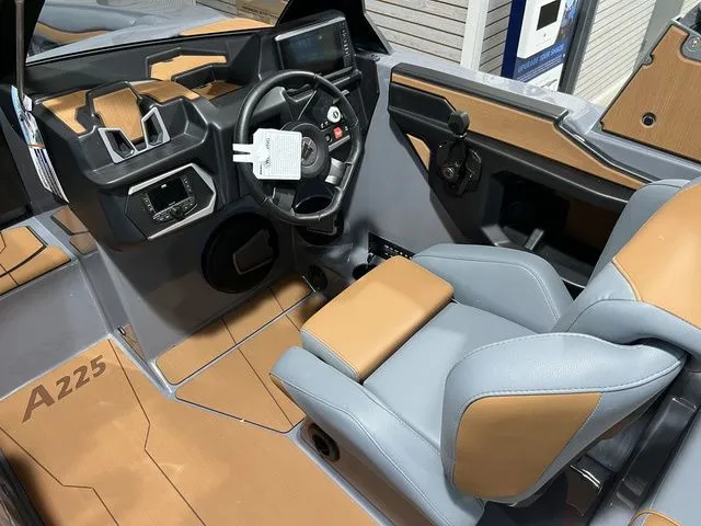 Slide: The Image of 2024 Axis Wake Research A225 boat interior with modern dashboard and leather seating. - 7