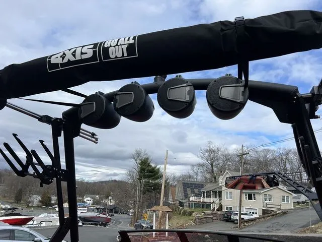 Slide: The Image of 2024 Axis Wake Research T235 boat speakers and tower against a cloudy sky backdrop. - 11