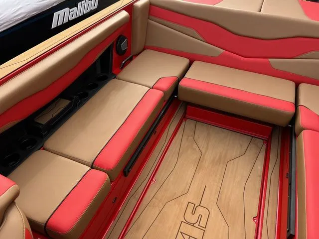 Slide: The Image of 2024 Axis Wake Research T235 boat interior with red and tan seating, wood flooring. - 13