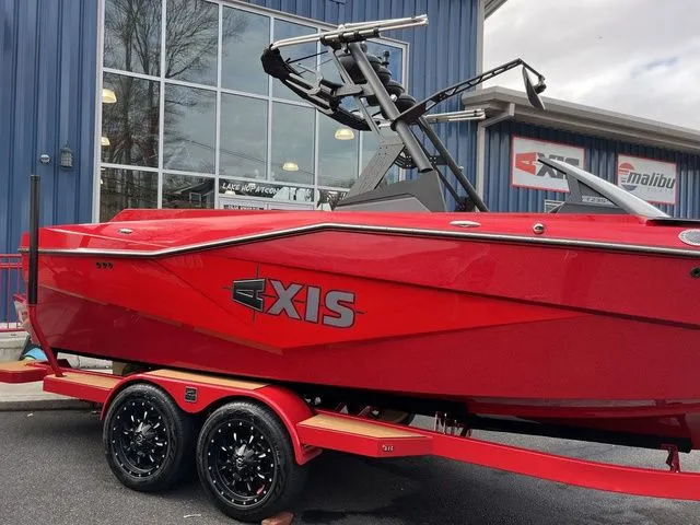 Slide: The Image of 2024 Axis Wake Research T235 boat in vibrant red on a trailer. - 14